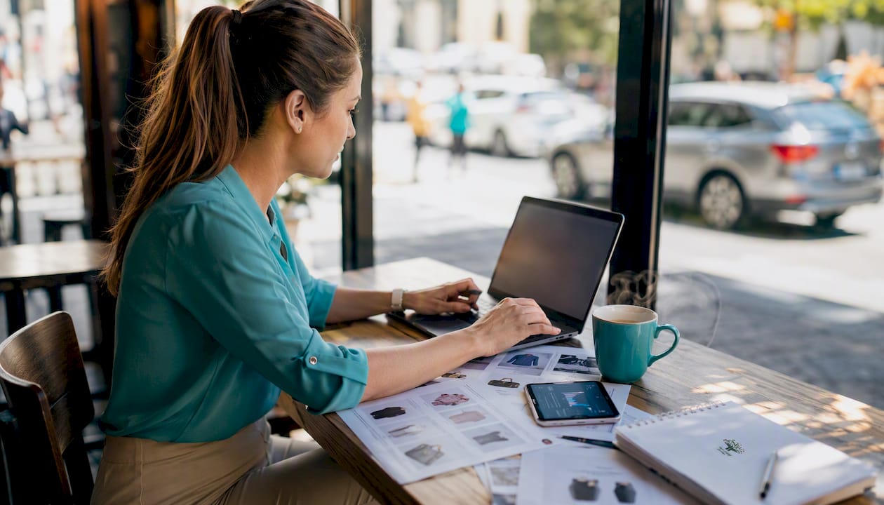 1785648801911_Woman-managing-product-feed-on-laptop-in-home-office Woman managing product feed on laptop in home office