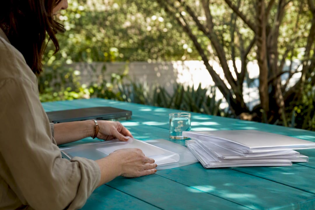 Hands setting down report folders on desk