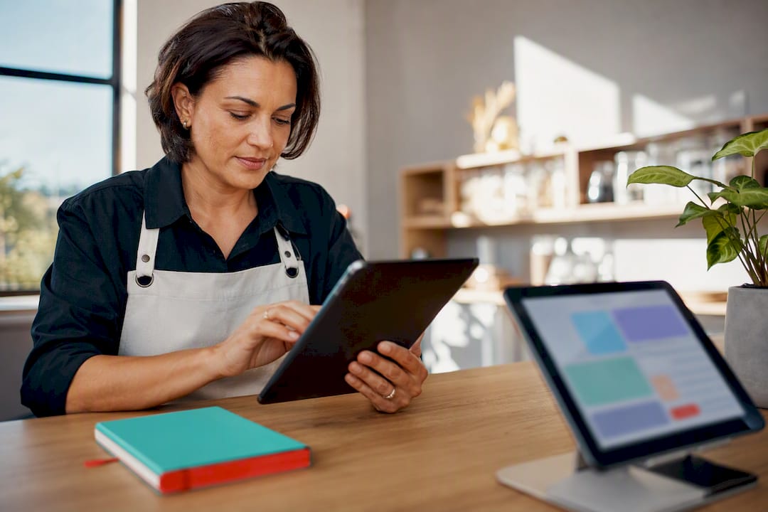 Small business owner coordinating connected digital systems